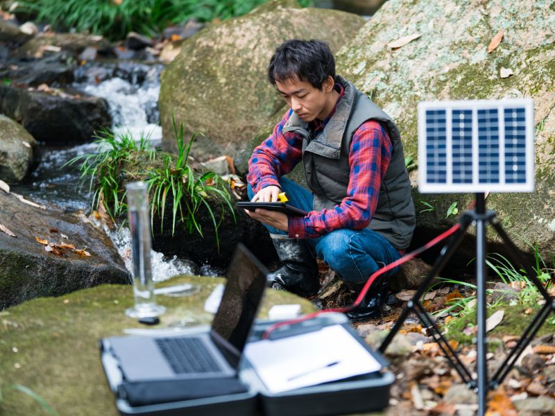 A professional working with sensors and computers to check water quality