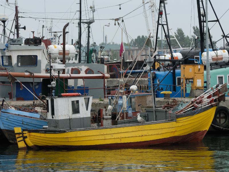 An industrial fishing boat docked at a fishing port.