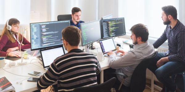 A software programmer coding on his computer