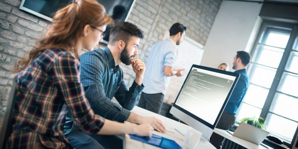 A group of programmers coding in their computers